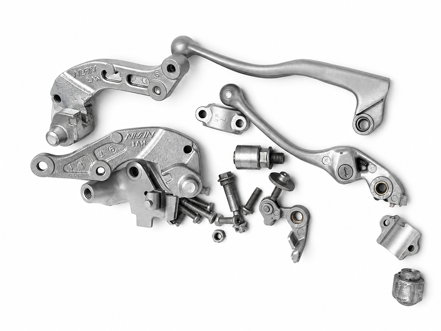 Assortment of vapour blasted motorcycle brake and lever components with a uniform satin aluminium finish