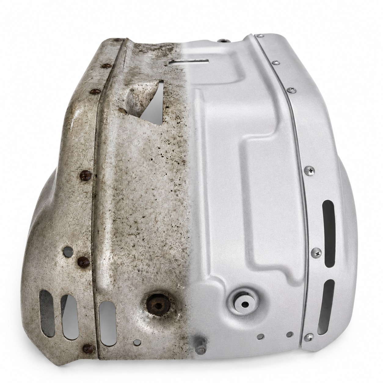 Motorbike engine pan half-restored by vapour blasting, showing transformation from corroded to clean satin finish